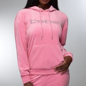 NWT Woman’s Medium Velour Light Pink Bebe Rhinestone Logo Zip Up Hoodie